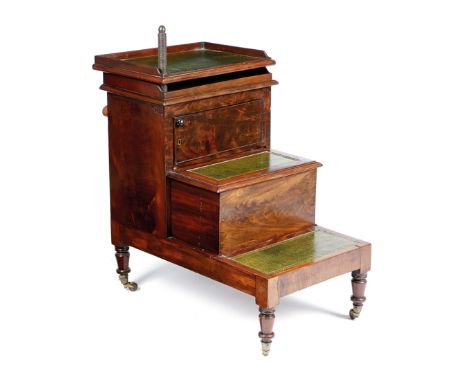 AN EARLY VICTORIAN BEDSIDE STEP COMMODE C.1840 inset with later gilt tooled green leather, with a twin swivel tray top above 
