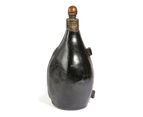 A LEATHER SADDLE FLASK 18TH CENTURY the spout with an oak stopper and brass rim, with stitched edges with two lugs 32cm high 