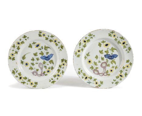 A PAIR OF DELFTWARE POTTERY CHARGERS POSSIBLY LIVERPOOL, MID-18TH CENTURY painted in blue, green, yellow and manganese with f