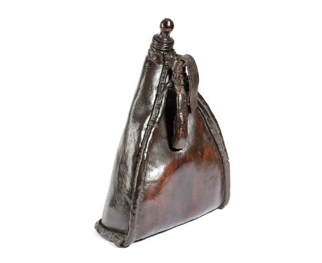 A LEATHER SADDLE FLASK 18TH CENTURY the spout with a turned fruitwood stopper, with a strap 43.5cm high Provenance The Peter 