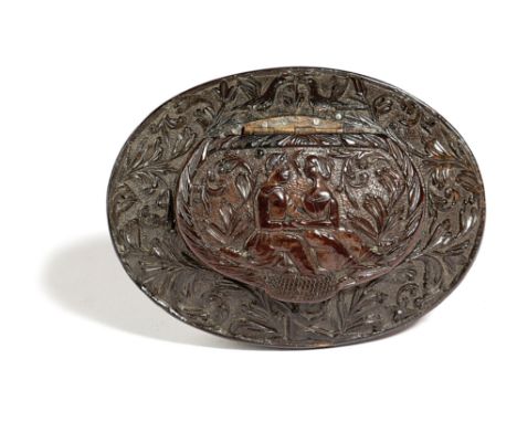 A TREEN COCONUT OVAL SNUFF BOX LATE 17TH / EARLY 18TH CENTURY relief carved with a young courting couple, scrolling leaves, l