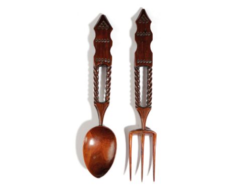 A TREEN YEW LOVE SPOON AND FORK WELSH, FIRST HALF 19TH CENTURY with chip carved decoration and spiral twist stems (2) 27cm lo