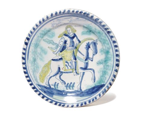 A DELFTWARE POTTERY EQUESTRIAN CHARGER PROBABLY LONDON, C.1700 painted in blue, green and yellow with a young man on horsebac