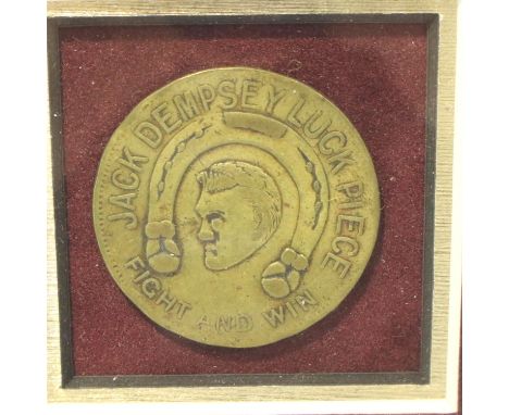 Framed brass Jack Dempsey Luck piece. P&amp;P Group 3 (£25+VAT for the first lot and £5+VAT for subsequent lots) 