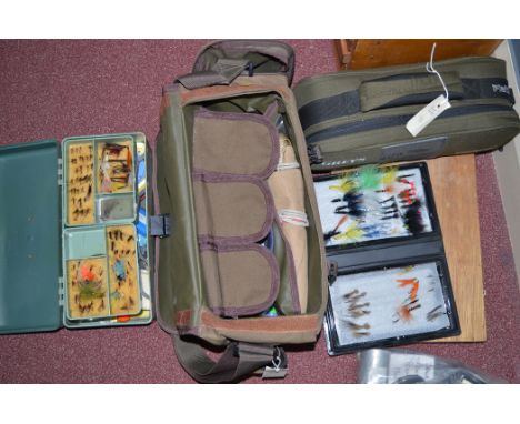 A modern tackle bag containing a cantilever box full of fly tying materials: various spools of fishing line, and a 'Platinum 