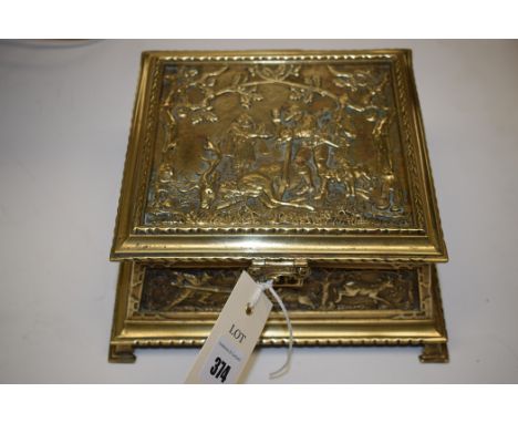 A 19th Century embossed brass casket, the lid and side panels depicting hunting scenes, interior lined with red velvet, the b