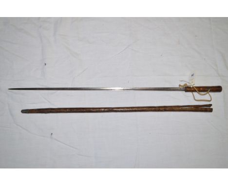 A 19th Century sword stick with fullered blade in rustic cane (distressed).