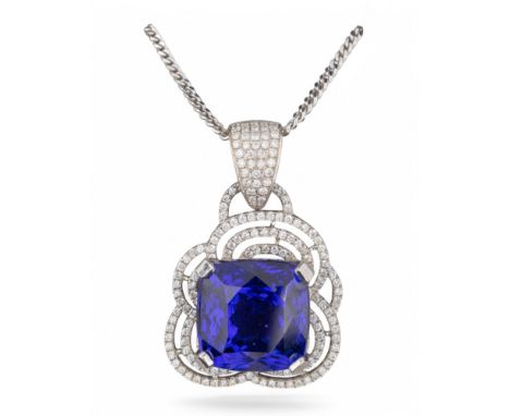 1990s An impressive tanzanite and diamond pendant. The cushion shaped mixed cut tanzanite of strong, even blue-purple colour.