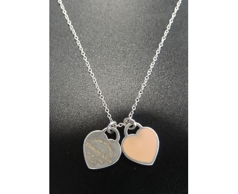 TIFFANY & CO. SILVER MINI DOUBLE HEART TAG PENDANT ON CHAINone heart with pink enamel, the other engraved 'Please return to T