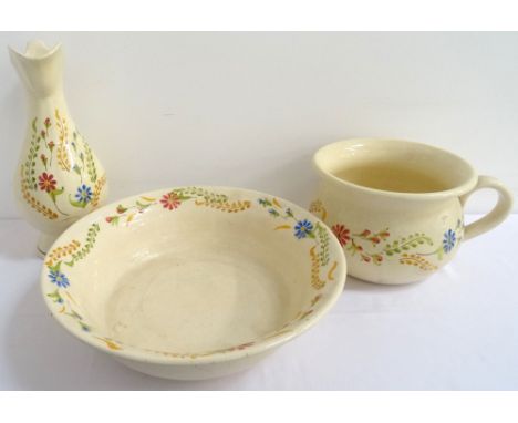 FRENCH POTTERY WASH BOWLand ewer with a cream ground and decorated with floral motifs, together with a matching commode (3) 