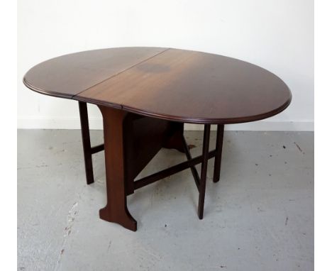 MAHOGANY GATE LEG DINING TABLEwith shaped drop flaps, standing on shaped supports, 105cm wide 