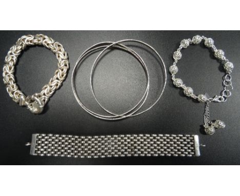 THREE SILVER BRACELETS AND AND A BANGLEcomprising a Tabra mesh effect bracelet, a pierced ball design bracelet, a fancy link 