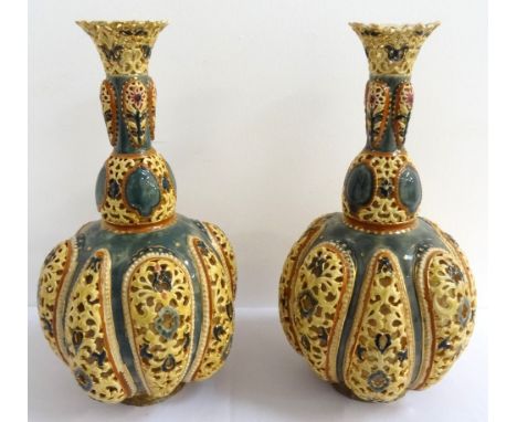 PAIR OF HIGHLY DECORATIVE ZSOLNAY PECS PIERCED POTTERY BOTTLE VASESthe pierced flared rim on each above a tapering neck and l