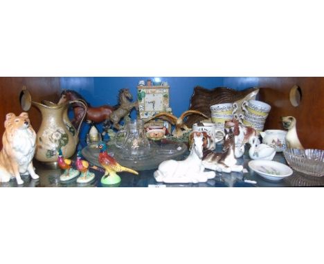 A Shelf of Decorative Items, to include a figural mantel clock, cup and saucer duos, animal figures, etc.