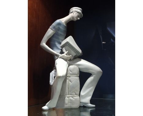 A Tall Lladro Figure of a French Sailor Playing an Accordion. 34cm.