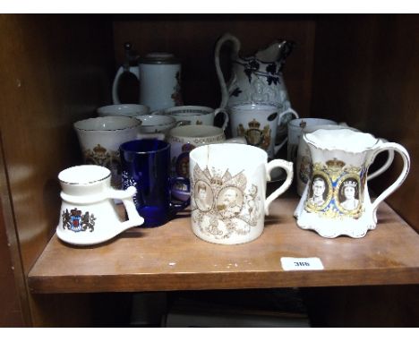 A Shelf of Commemorative Beakers, Mugs and Tankards to include painted blue glass 1897 Victoria Jubilee.