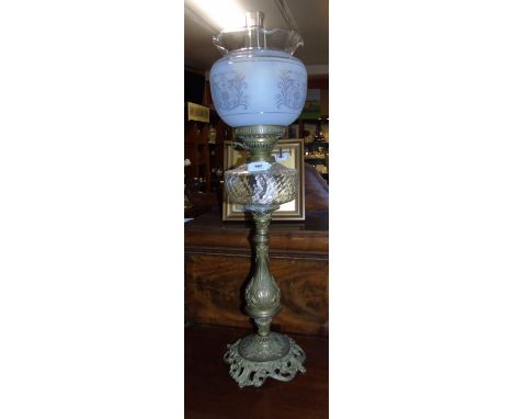 An Oil Lamp in the Victorian Style with frosted glass shade.