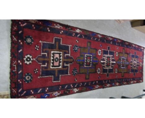 A Red Ground Hand Woven Persian Runner, 292 x 90cm.