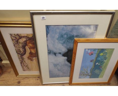 A framed print of lions, another of a lighthouse and another of flowers 