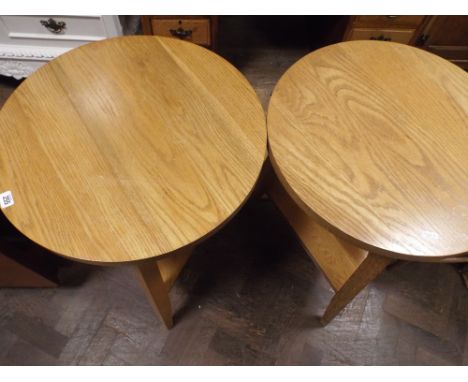 A pair of circular light oak 2 tier lamp or occasional tables 