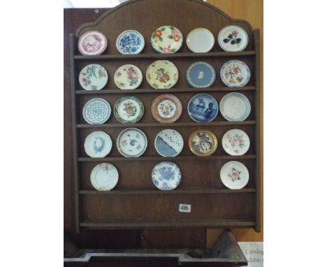 Wall mounted plate rack and a collection of miniature wall plates to include examples by Royal Copenhagen and Worcester 