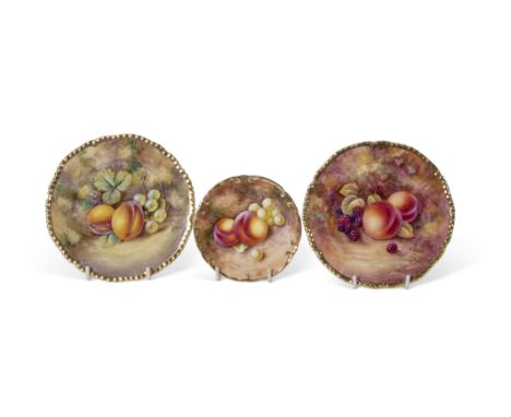 Group of three small Royal Worcester plates, all decorated with fruit, one signed J Skerrett, within a gadrooned gilt rim, a 