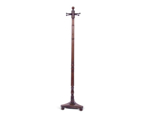 Regency mahogany cloak stand with a ring turned column to a triple splayed base, ball finial and four turned post pegs, 170cm