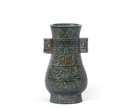 Chinese vase of archaic form with scroll decoration on a green, probably quartz, ground, 24cm high