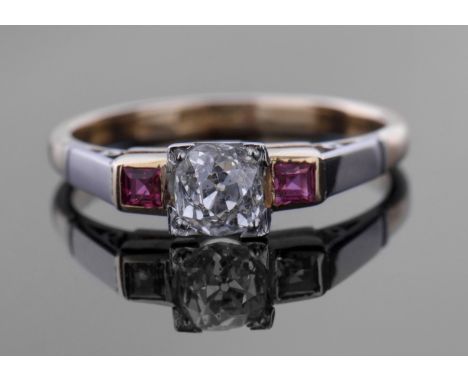 Art Deco diamond and ruby ring featuring a round brilliant cut diamond, 0.40ct approx, raised in a box setting between calibr