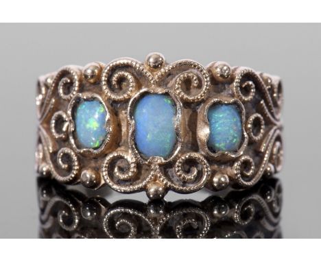 Opal three stone ring, the ornate filigree carved style gallery with three small graduated cabochon opals, stamped 14K, size 