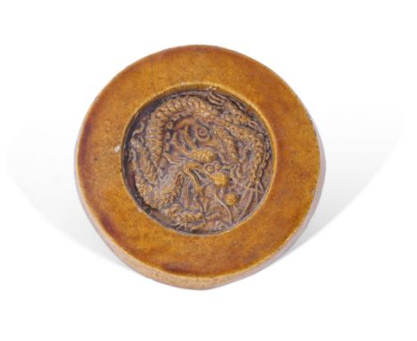 Chinese roof tile from Tiananmen Square, the circular tile with a dragon in relief to centre, in light brown glaze. Provenanc