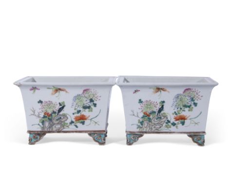 Pair of late 18th/early 19th century Chinese porcelain planters with polychrome designs of flowers and rock work, on four sma