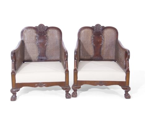 Late 19th/early 20th century mahogany Bergere suite, comprising a double canned two-seater sofa and two matching easy chairs,