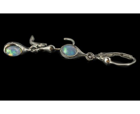Opal Solitaire Lever Back Drop Earrings, oval cabochon cut opal solitaires, each in a rub over setting in a classic teardrop 
