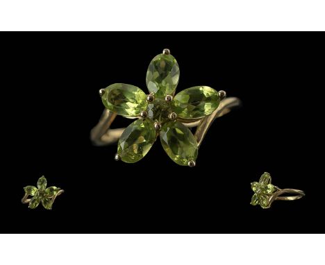 Peridot Floral Design Ring, a five petalled flower comprising five pear cut peridots with a smaller, round cut to the centre,