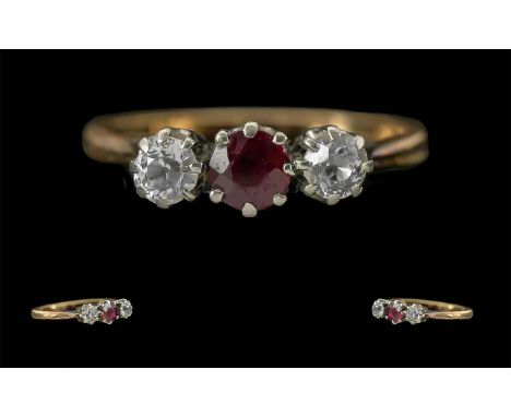 Ladies 18ct Gold Attractive 3 Stone Diamond and Ruby Set Ring, Marked 18ct to Interior of Shank. The Central Ruby Flanked by 