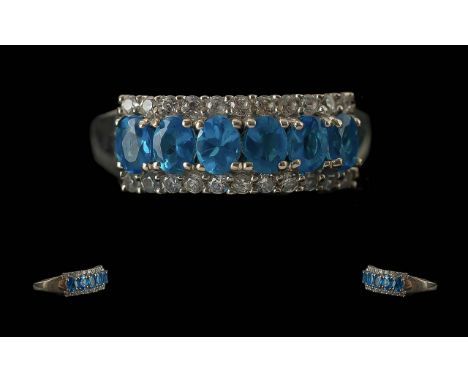 Neon Apatite Half Eternity Ring, a row of faceted oval cuts of the brightest and rarest of the apatite colours, neon apatite,