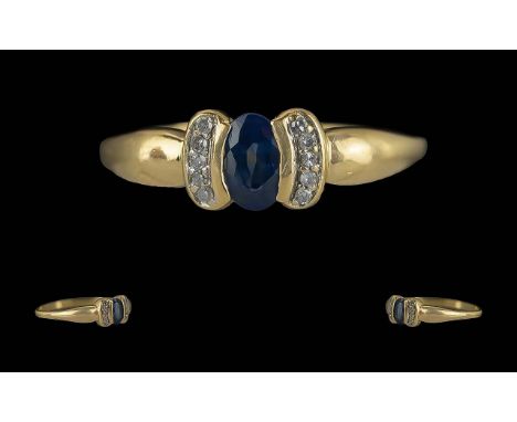 Ladies Pleasing 14ct Gold Contemporary Sapphire and Diamond Set Ring, not marked but tests high carat gold, the centre blue s