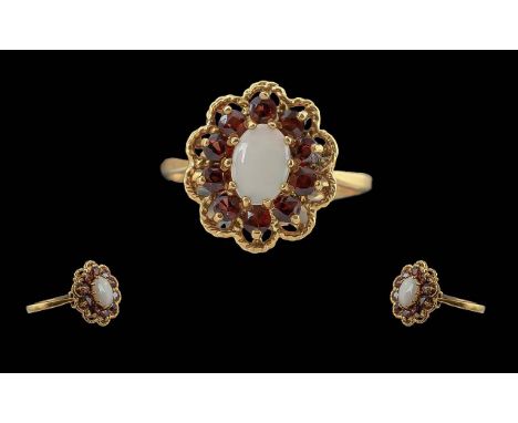 Ladies 9ct Gold Opal &amp; Garnet Set Cluster Ring, flowerhead design.  Marked to interior of shank.  The central opal surrou