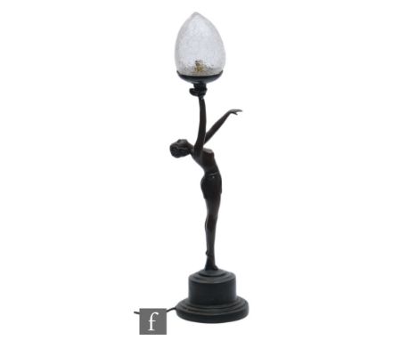 Crosa - A later 20th Century table lamp in the Art Deco style, resin in bronzed finish, formed as a semi clad female with arm