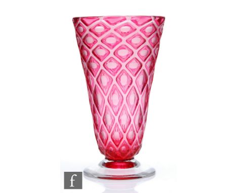 Edinburgh &amp; Leith - A post war glass vase of footed flared form, cased in ruby over clear and cut with ovals within a dia