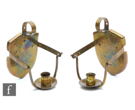 Unknown - A pair of Arts and Crafts style candle stick wall sconce each with a shield shaped back, loop handle and swinging s