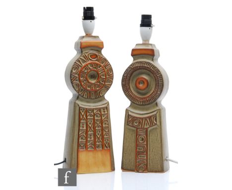 Manner of Bernard Rooke - A pair of 1970s stoneware Totem lamp bases, each carved and moulded with biscuit and buff glazes, u