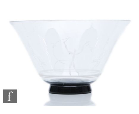 Vicke Lindstrand - Orrefors - A 1930s clear crystal bowl of footed flared form with a black foot, engraved decorated with a s