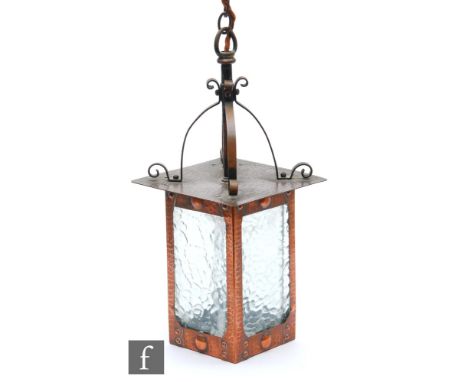 Unknown - An early 20th Century Arts and Crafts copper hanging lantern, the beaten copper body with glass panels, unmarked, h