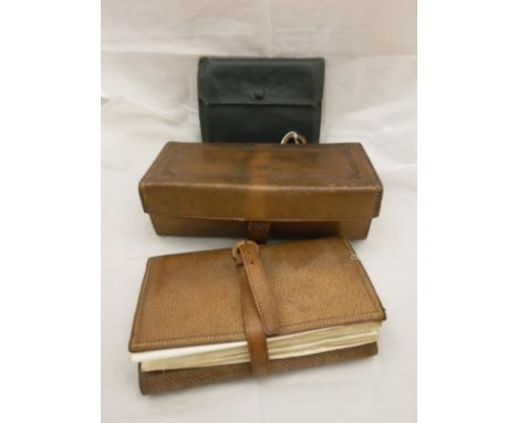 A collection of two fly wallets and a leather case, the pig skin fly wallet containing a number of parchment leaves holding a