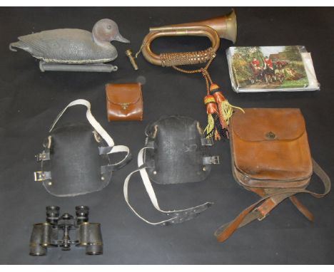 A box containing various country pursuit requisites including binoculars, leather bags, pen knife, decoy duck, copper and bra