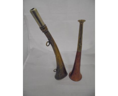 A brass horn by J Tournier of Paris inscribed "Nord", together with a copper and brass hunting horn