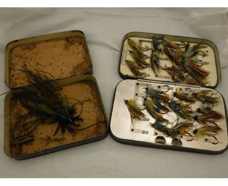 Two japanned tackle boxes, one cork-lined and containing a large Victorian hand-tied salmon fly measuring 35/8" and a small b