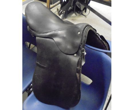 A dressage saddle, together with three boxes of assorted tack, blankets, boots, whip, etc a hunting jacket and a faux fur shr